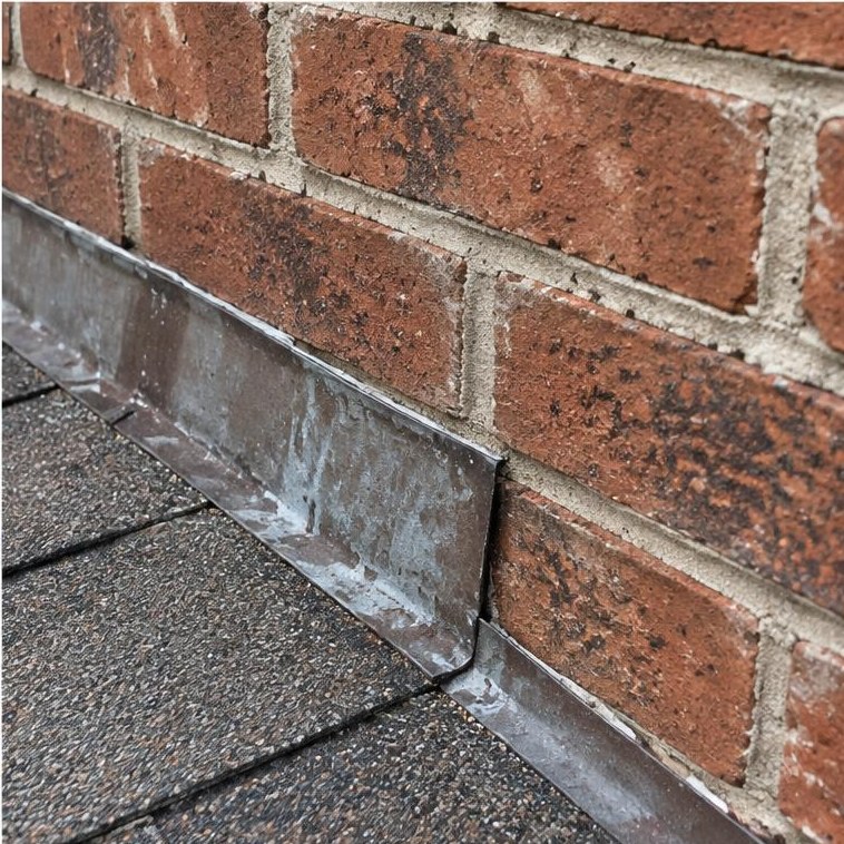 Roof and chimney flashing junction