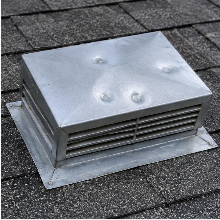 Hail dents on a metal roof vent