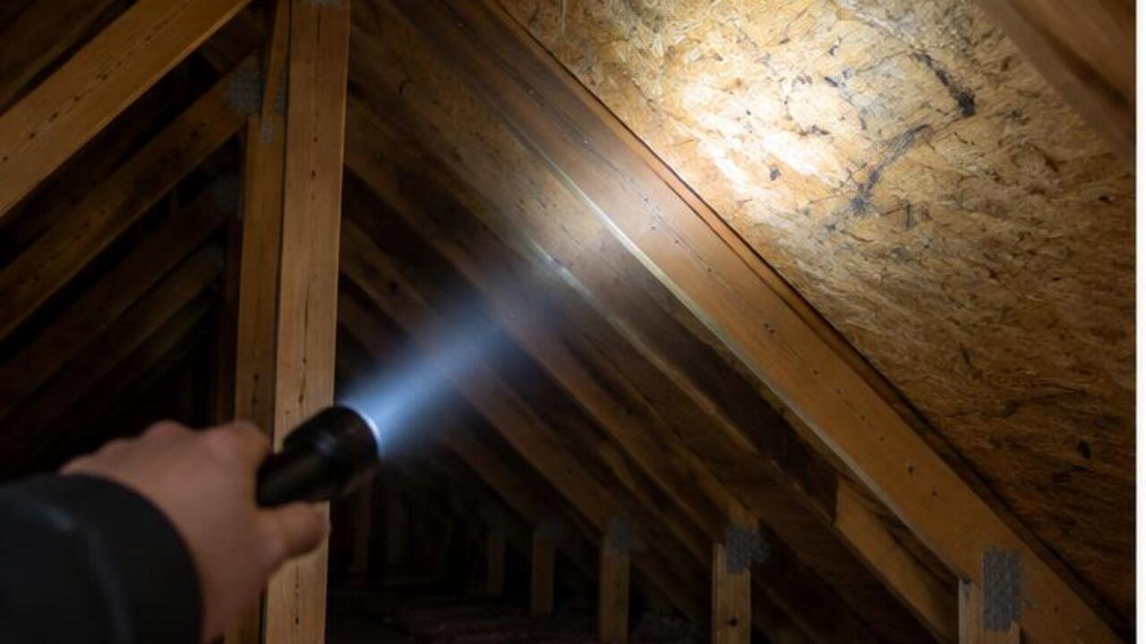 Flashlight beam on the underside of roof decking in an attic